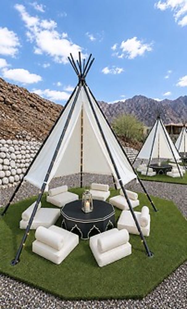 A teepee dressed with sheer drapes for an event