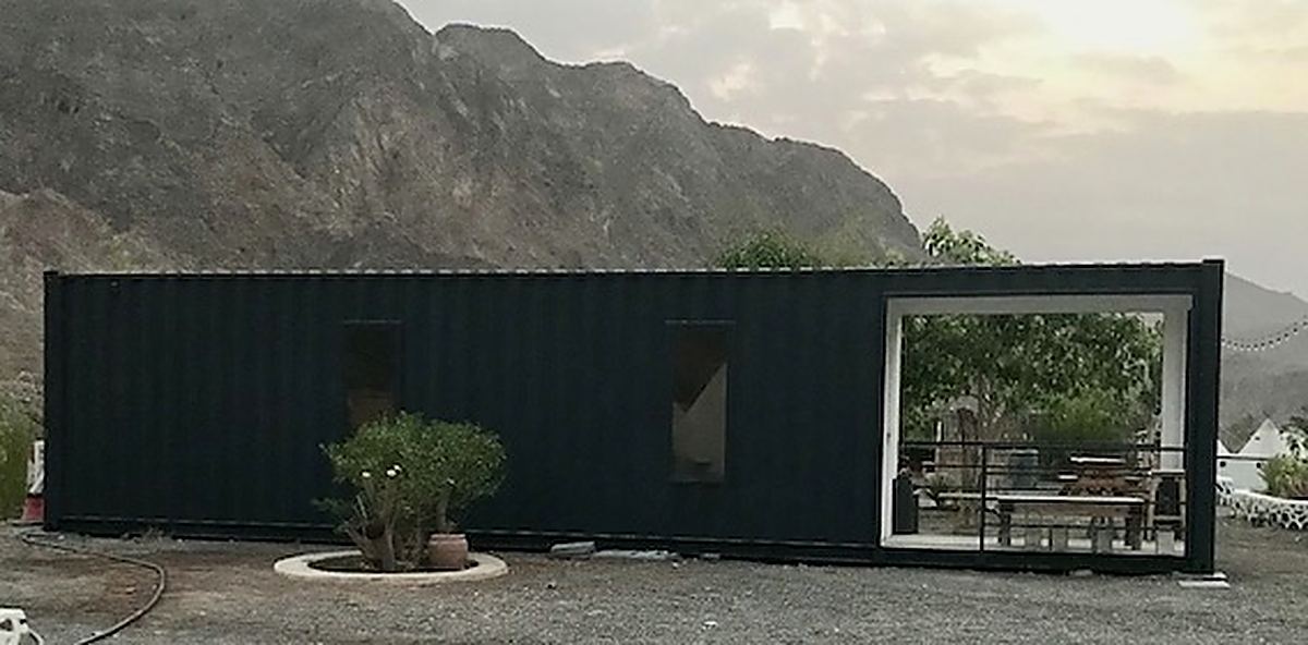 A modified 40ft container fitted out as a site office with a glazed front and verandah
